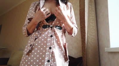 Gorgeous babe with big tits teases in a sexy BDSM dress.